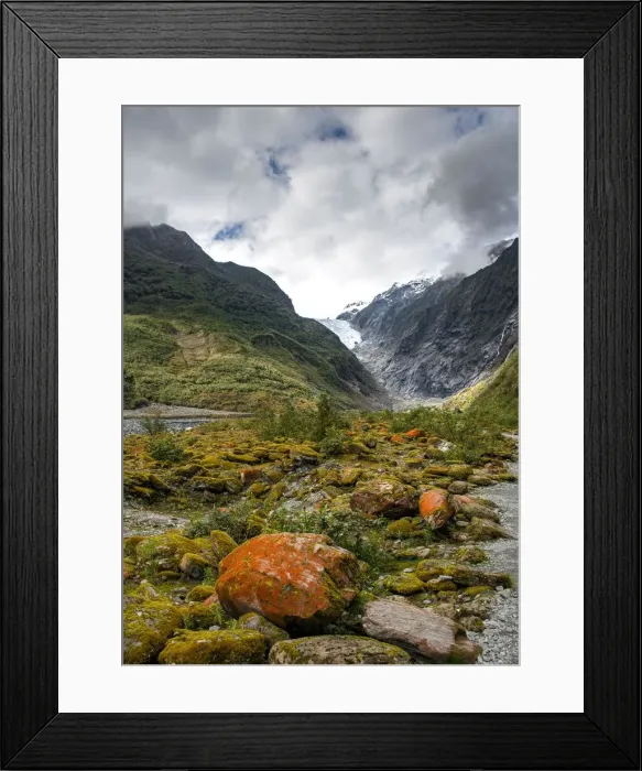 Framed Print : Rocks covered with moss and red lichens, in the back glacier tongue of Franz Josef Framed Print : Rocks covered with moss and red lichens, in the back glacier tongue of Franz Josef