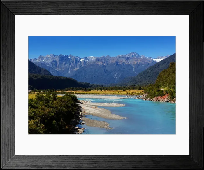Framed Print : Turquoise-colored Whataroa River with snowcapped Southern Alps on horizon on autumn
