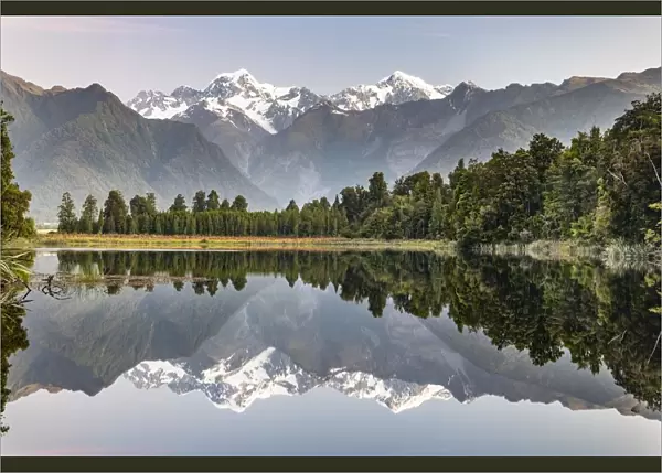 View of snow-covered Mount Cook and Mount Tasman, reflection in Lake Matheson