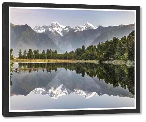View of snow-covered Mount Cook and Mount Tasman, reflection in Lake Matheson