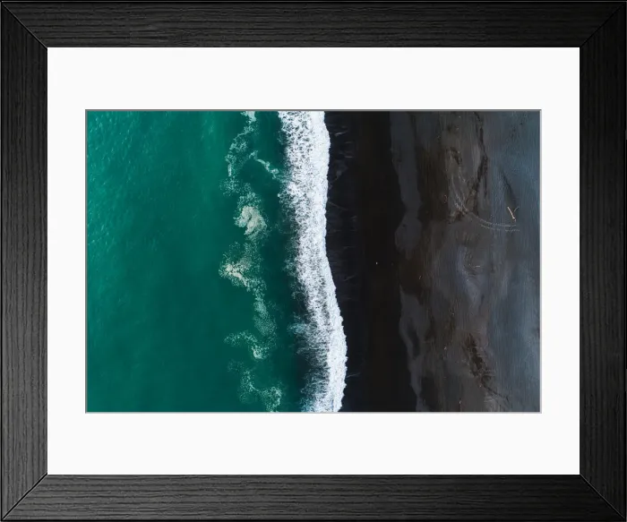 Framed Print : Looking down at black sand beach