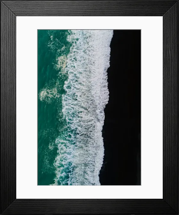 Framed Print : Looking down at black sand beach