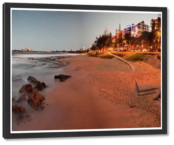 Mooloolaba Beach in the early evening at dusk with the lights of the buildings lit up