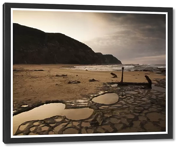 The anchor of the Marie Gabrielle shipwreck and rock pool reflections on Wreck Beach at