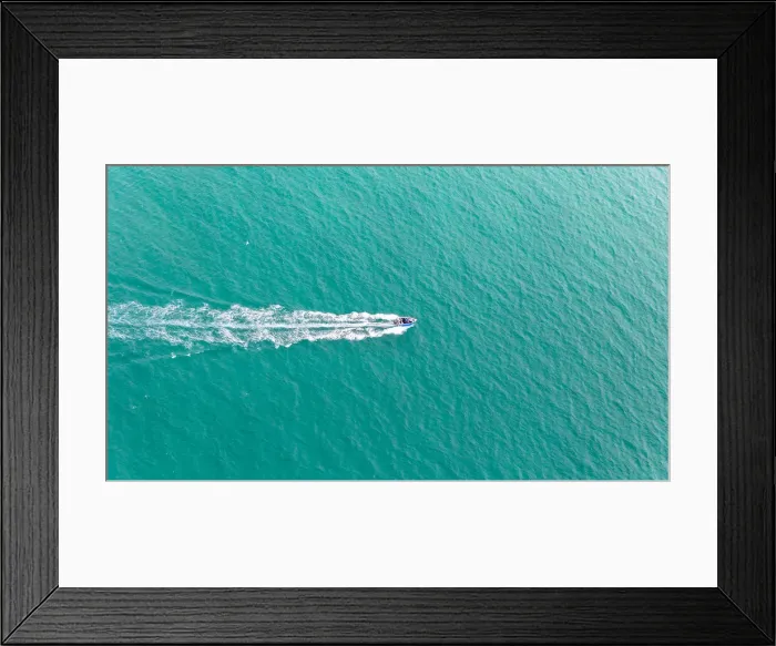 Framed Print : Aerial view of fast travelling boat on an island Framed Print : Aerial view of fast travelling boat on an island