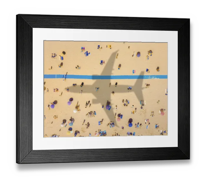 Framed Print : Aerial view of an airplane shadow over a crowded sandy beach