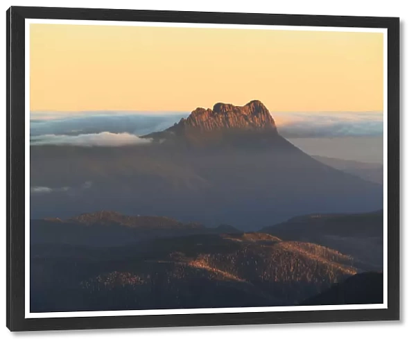 Precipitous Bluff rising above Southwest Tasmania at sunset viewed from Mt Geeves