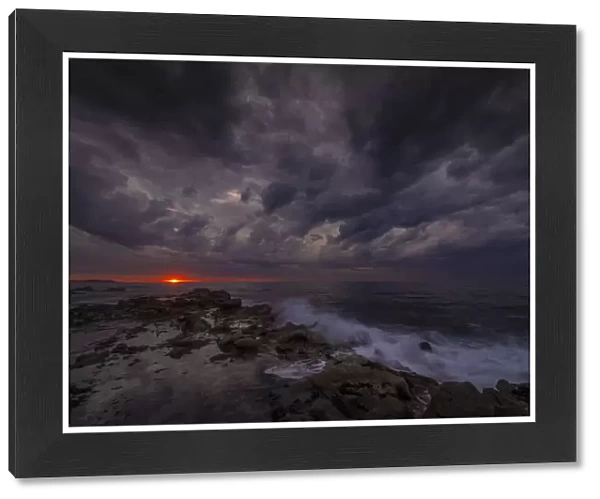 Black beach at dawn, and a dramatic storm filled sky, Bass coast, Victoria, Australia