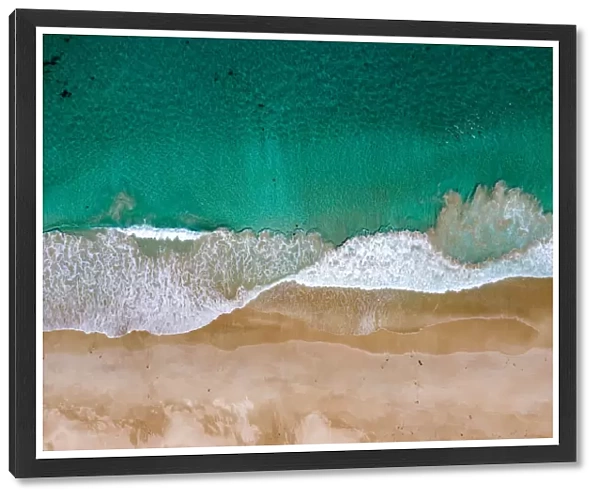 Aerial shot above turquoise ocean and beautiful sandy beach