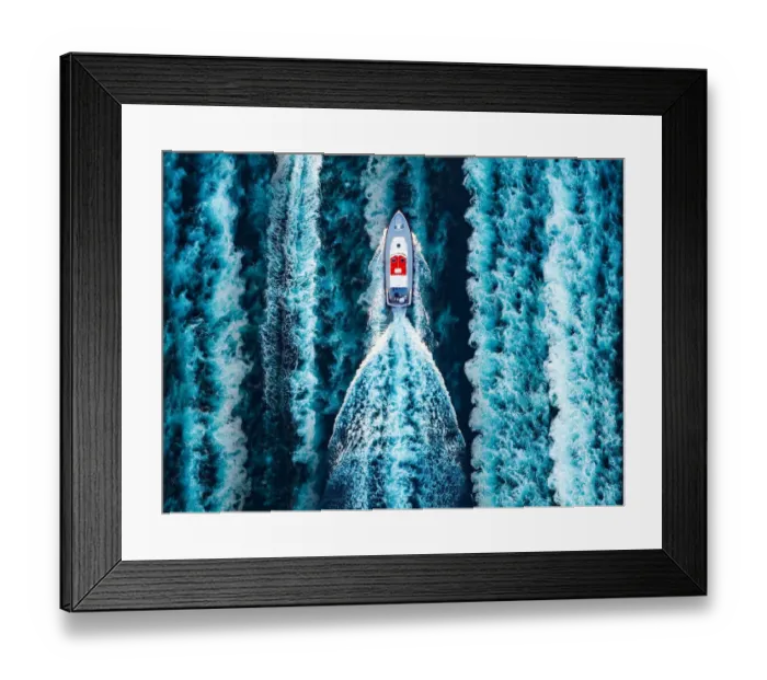 Framed Print : Aerial view of a motorboat surrounded by boat water wakes
