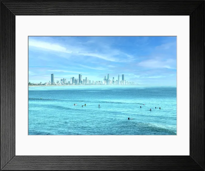 Framed Print : People surfing in the blue ocean waters of the Gold Coast with city skyline Framed Print : People surfing in the blue ocean waters of the Gold Coast with city skyline