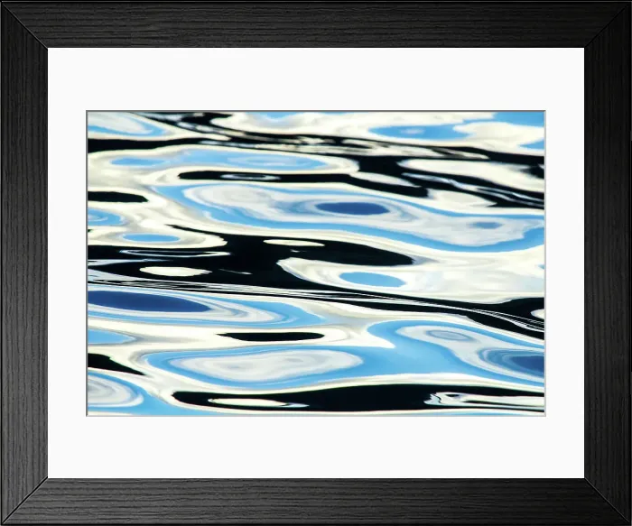 Framed Print : Blue, black and white colours reflected in the sea. Calm ocean water Framed Print : Blue, black and white colours reflected in the sea. Calm ocean water
