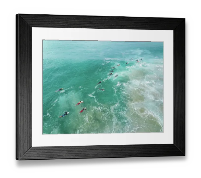 Framed Print : Aerial shot showing surfers paddling out to the waves on the Coral Sea, Gold Coast, Queensland, Australia