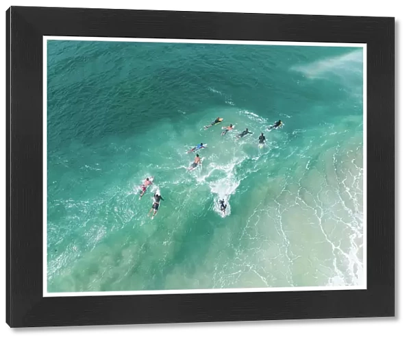 Surfers on the Coral Sea shot from a high angle perspective, Gold Coast, Queensland, Australia