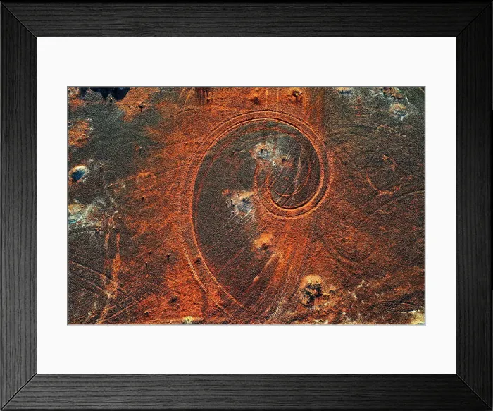 Framed Print : Abstract swirl pattern from car tyre tracks in red dirt, illuminated by dusk sunlight, remote rural Australia Framed Print : Abstract swirl pattern from car tyre tracks in red dirt, illuminated by dusk sunlight, remote rural Australia