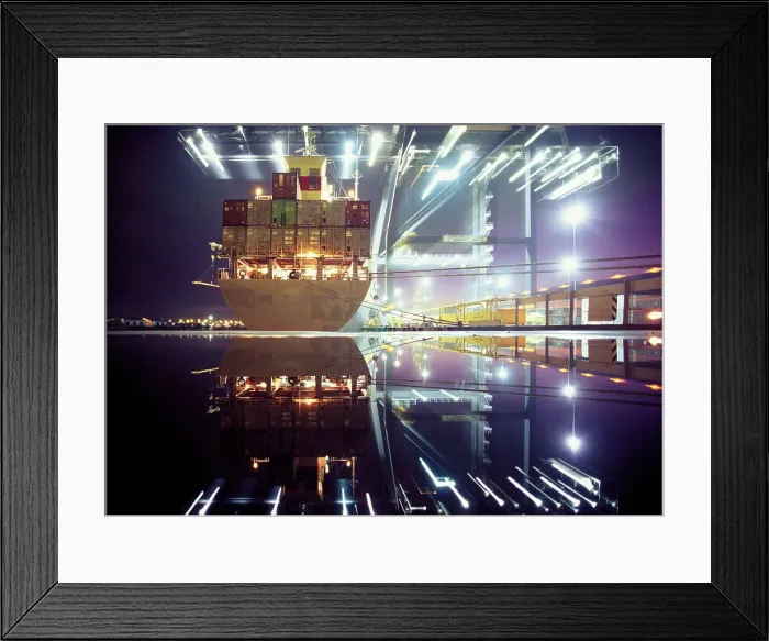 Framed Print : Container ship being loaded by illuminated cranes in dock, night Framed Print : Container ship being loaded by illuminated cranes in dock, night