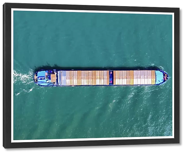 Aerial top view of a cargo container ship - transportation, import, export, logistics, commodity business in open sea