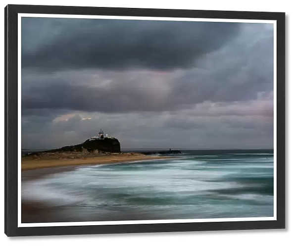 sunrise and a stormy mood at lighthouse and beach