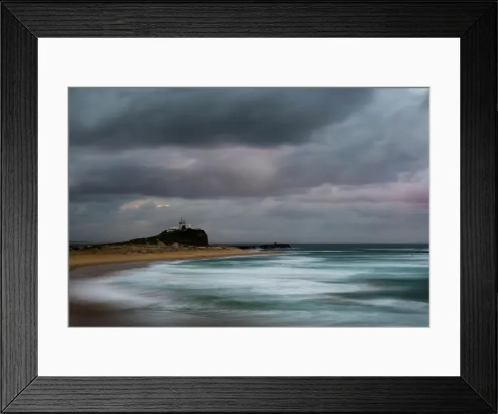 Framed Print : sunrise and a stormy mood at lighthouse and beach Framed Print : sunrise and a stormy mood at lighthouse and beach