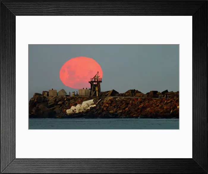 Framed Print : moon rise in front of tower and people as a silhouette Framed Print : moon rise in front of tower and people as a silhouette