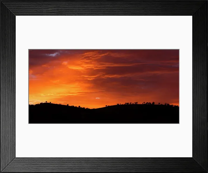 Framed Print : sunrise colours in the clouds with silhouette of mountain
