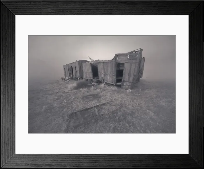 Framed Print : Vintage wooden train wagons in disrepair in a foggy field