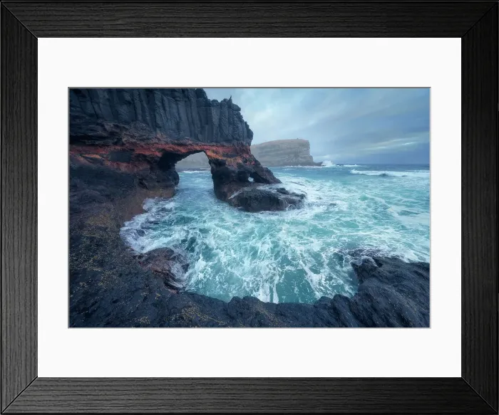Framed Print : Dramatic rocky cliffs, with rock columns and caves, breaking waves and distant coastline in Victoria, Australia