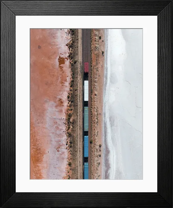 Framed Print : Drone image looking down on a freight train crossing a salt lake, South Australia, Australia