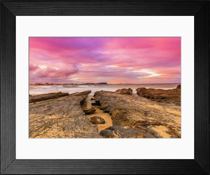 Framed Print : Bright and vibrant colored Sunset over the ocean with rock formations Framed Print : Bright and vibrant colored Sunset over the ocean with rock formations