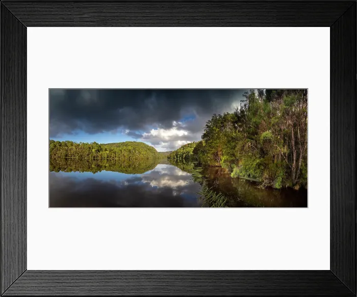 Framed Print : Reflected light over the Pieman river in the Tarkine wilderness area on the west coast of Tasmania