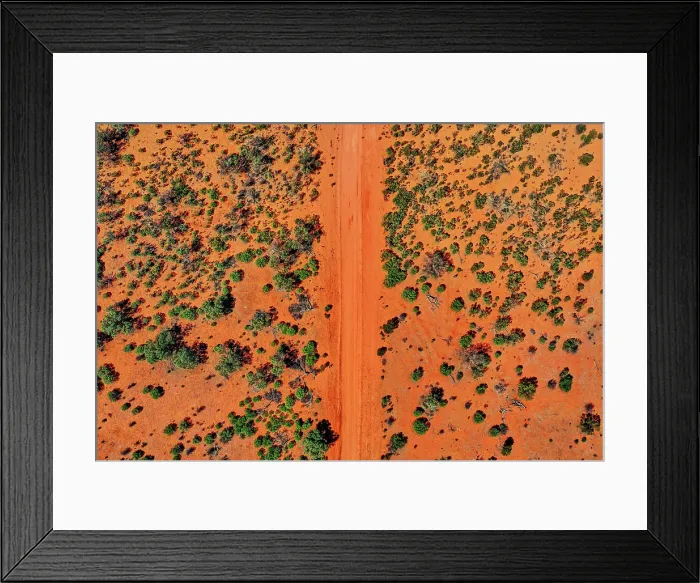 Framed Print : Red dirt road and trees, Australia, aerial view