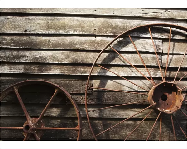 Old Wheels Against A Wooden Wall