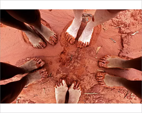 Feet in red sand on beach in Broome, WA