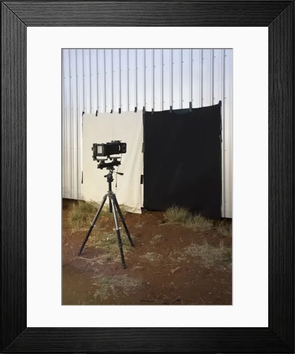 Framed Print : A camera and back drop set up outdoors