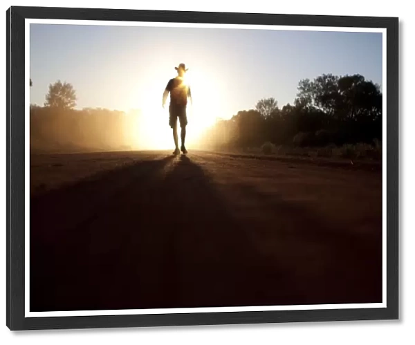 Australian bush man walking in the dust