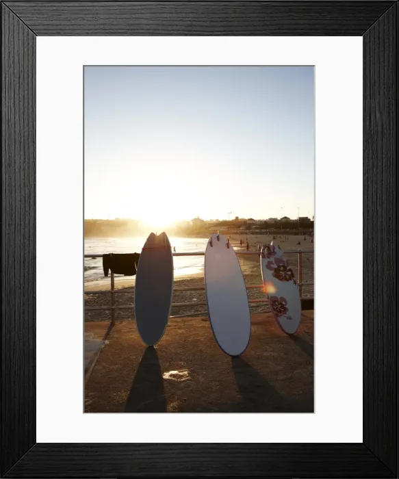 Framed Print : Surfboards leaning against railing