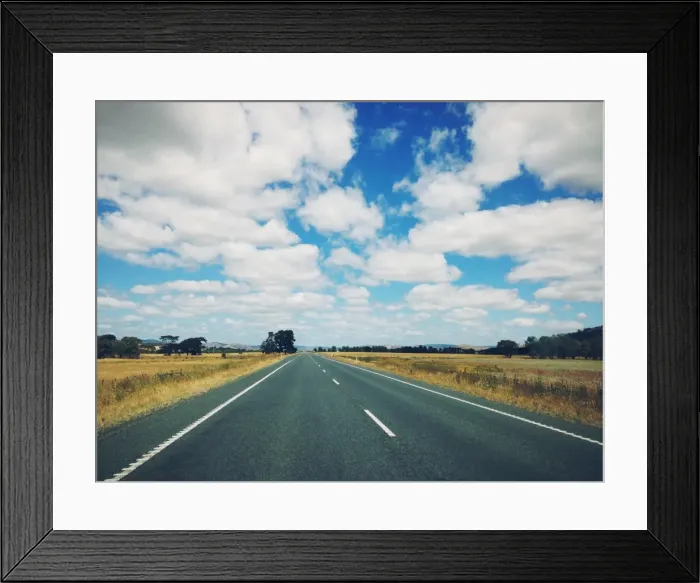 Framed Print : Dappled cloud over an empty highway