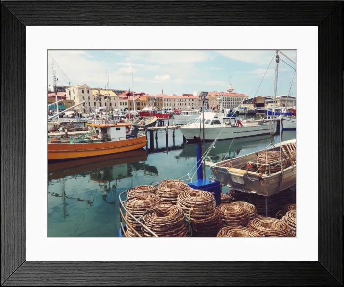 Framed Print : Fishing boats moored at a wharf in a city Framed Print : Fishing boats moored at a wharf in a city