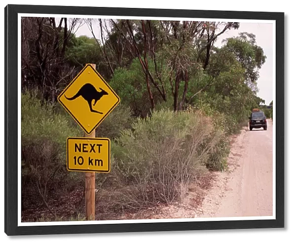 Australia, dirt road with kangaroo crossing sign