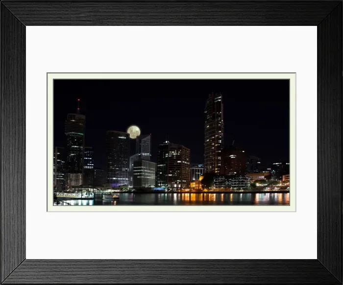 Framed Print : Moon rises over darkened cityscape Framed Print : Moon rises over darkened cityscape