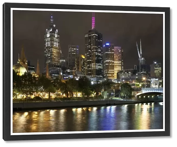 Australia, Victoria, Melbourne city skyline and Yarra River, night