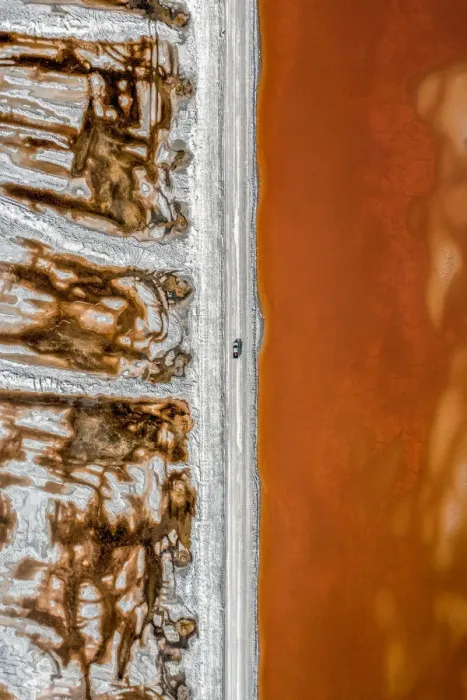 Framed Print : Aerial shot of an dirt track and a truck alongside vibrant coloured salt ponds Framed Print : Aerial shot of an dirt track and a truck alongside vibrant coloured salt ponds