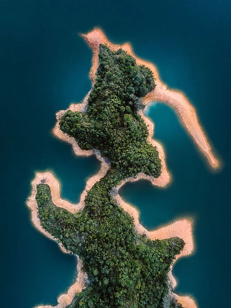 Aerial shot of unique shaped island with a forest, Hong Kong