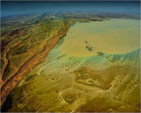 An Aerial view of the Australian outback in flood, showing the vibrant colours of the Landscape