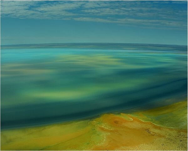 An Aerial view of the Australian outback in flood around Lake Eyre, showing the vibrant colours of the Landscape