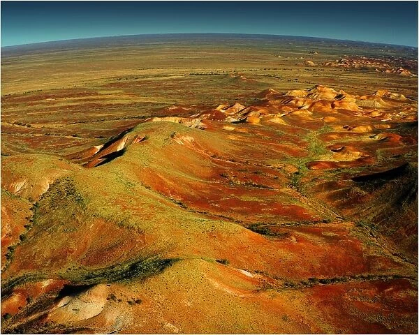 An Aerial view of the Australian outback over the Painted desert, showing the vibrant colours of the Landscape
