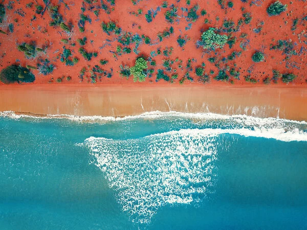 Aerial top view of a bright orange sandy beach