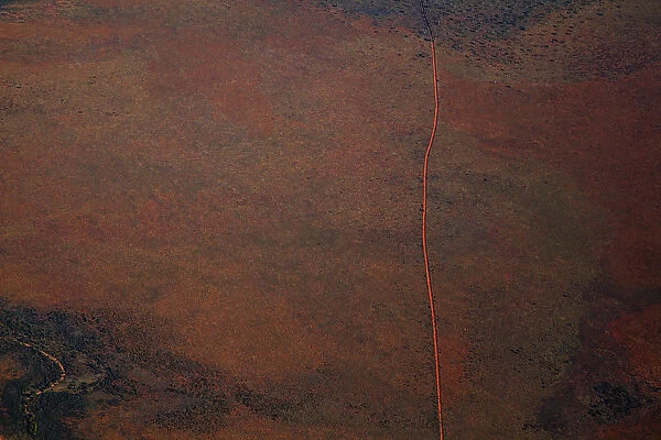 Aerial view of a dirt road positioned in a remote landscape