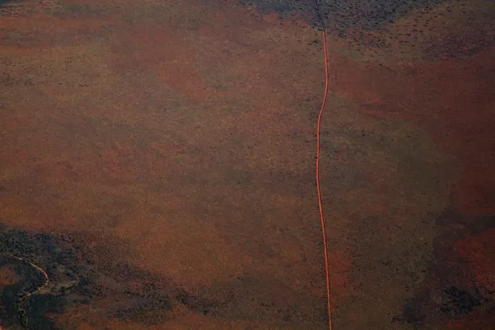 Framed Print : Aerial view of a dirt road positioned in a remote landscape