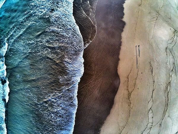 Aerial view of waves breaking on beach